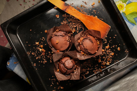 Cake of chocolate fondant cake, chocolate muffins with walnuts, raisins and grated chocolate, and dark chocolate bars on a dark black background. Perfect for creating a recipe book.の写真素材