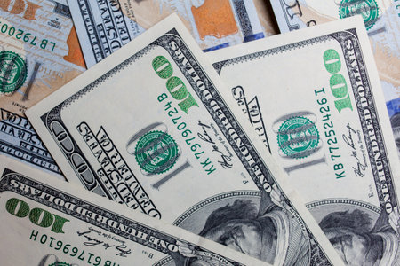 Many banknotes in face value of 100 dollars on the front and back. Income, investment, successful business. Background close-up of US dollars, background texture of US dollarsの写真素材
