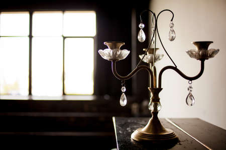 metal vintage candlestick on a blurred background.の写真素材