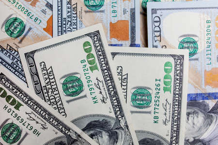 Many banknotes in face value of 100 dollars on the front and back. Income, investment, successful business. Background close-up of US dollars, background texture of US dollarsの写真素材