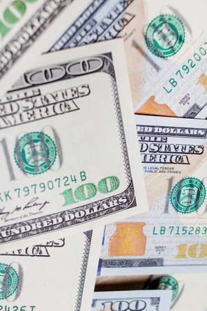 Many banknotes in face value of 100 dollars on the front and back. Income, investment, successful business.の写真素材