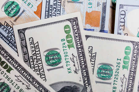Many banknotes in face value of 100 dollars on the front and back. Income, investment, successful business.の写真素材