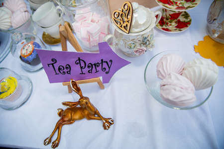 Holiday themed table for the tea ceremony. Table with sweets. Tea with sweets. Table of Alice in Wonderlandの写真素材