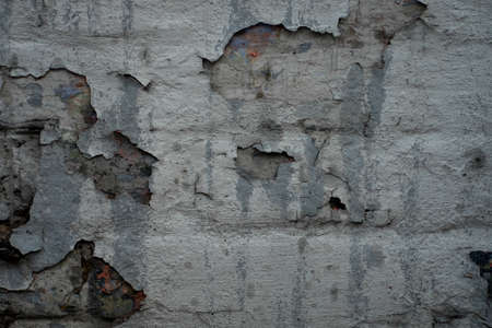 Brick wall with the whitewash falling off fragment as a background texture. Vintage or grungy white background of natural cement or stone old texture as a retro pattern wall.の写真素材