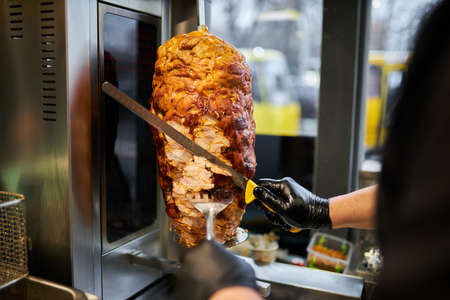 shawarma, lamb on a spit. street food. Doner Kebab on a rotating spit. A street food of Turkey. Gyros, doner grilled slowly on rotating spits.の写真素材