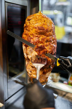 shawarma, lamb on a spit. street food. Doner Kebab on a rotating spit. A street food of Turkey. Gyros, doner grilled slowly on rotating spits.の写真素材