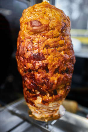 shawarma, lamb on a spit. street food. Doner Kebab on a rotating spit. A street food of Turkey. Gyros, doner grilled slowly on rotating spits.の写真素材