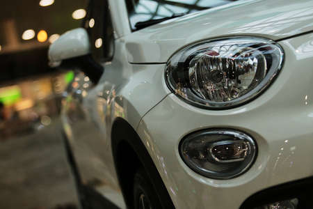 Headlights, white car. headlights of a new white car on a bokeh background.の写真素材