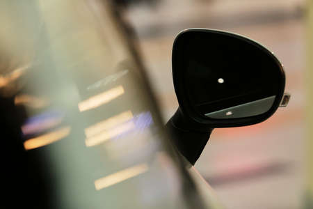 Mirrors, white car. Rear-view mirrors of a new white car with bokeh background.の写真素材