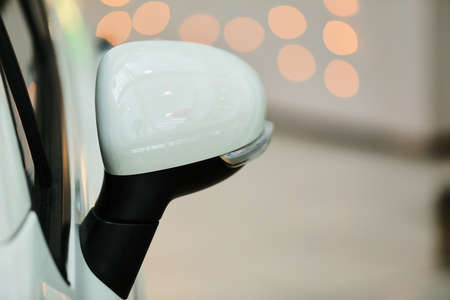 Mirrors, white car. Rear-view mirrors of a new white car with bokeh background.の写真素材