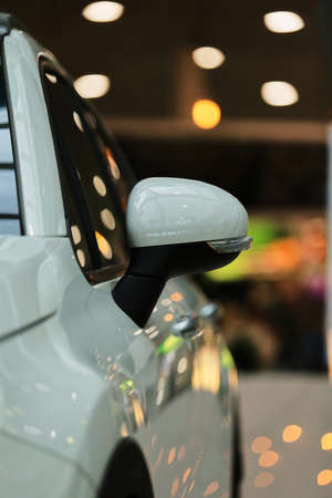 Mirrors, white car. Rear-view mirrors of a new white car with bokeh background.の写真素材