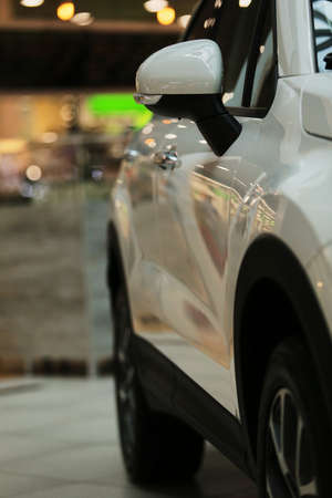 Mirrors, white car. Rear-view mirrors of a new white car with bokeh background.の写真素材