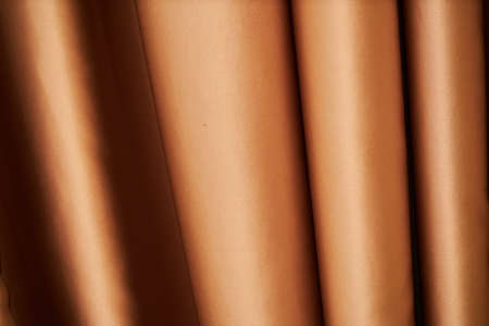 theatrical golden curtain. close-up of golden curtain - photographed, not illustrated. Golden curtain background.の写真素材