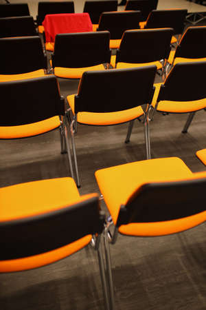 Black and orange plastic conference chairs. black and orange chairs in the conference room. background of black and orange chairs.の写真素材