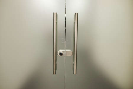 Glass frosted door with a metal handle. glass door. Frosted glass backgroundの写真素材