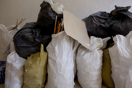 Bags with construction waste and wood. Full debris of construction debris, garbage bricks and material from the destroyed house. White bags filled with used building materials and waste.close-up photoの写真素材