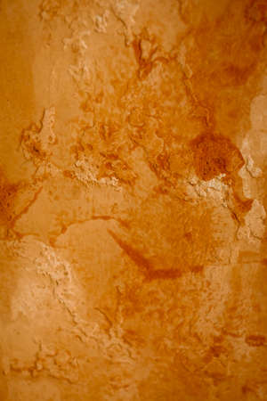 Bright grunge wall texture. Grunge vintage stone wall background texture with orange texture of husk, stain paint. Vintage orange wall wallpaper. Texture wall, orange grunge background, stain.の写真素材