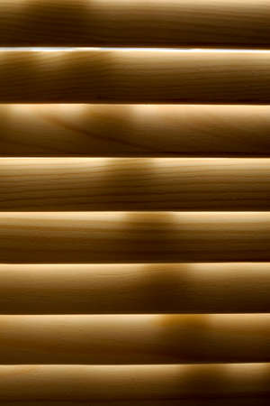 Window shutters. Arched windows with a lattice.Light through the arched windows. Wooden shutters on arched windows. A photo of a wooden shutter, shutter close-up.の写真素材