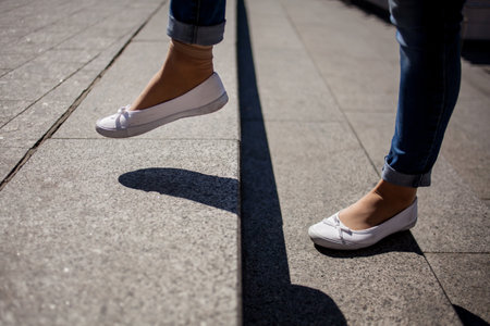 Young adult woman walking up the stairs. The girl is walking on the steps. legsの写真素材