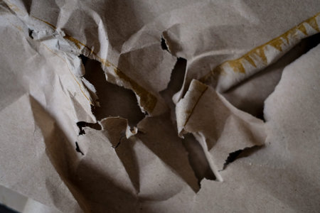 Crumpled, torn cardboard paper. Broken, crinkled brown paper with beige paper. Texture for design...