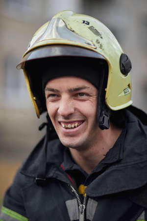 Kiev, Ukraine, November 20, 2021: Close-up portrait of a firefighter. Smiling firefighter. Portrait of a middle-aged firefighter in uniform. portrait of a Caucasian firefighter in full rescue gear.のeditorial素材