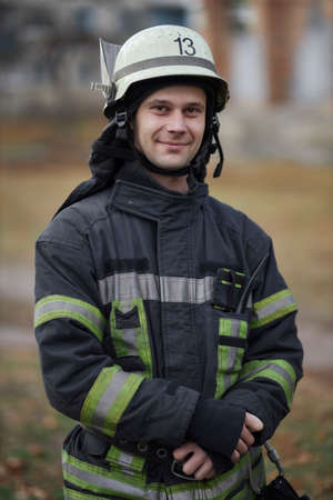 Kiev, Ukraine, November 20, 2021: Close-up portrait of a firefighter. Smiling firefighter. Portrait of a middle-aged firefighter in uniform. portrait of a Caucasian firefighter in full rescue gear.のeditorial素材