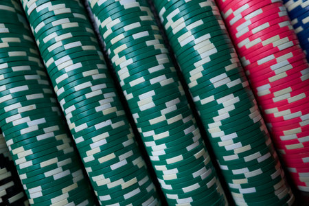 Poker chips colorful gaming pieces lie on the game table in the stack. Background for gambling,...