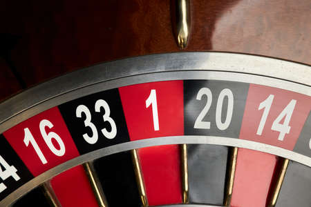 Casino theme, betting, online casino. image of red color casino roulette, poker game. roulette wheels. online casino, bets, winnings. luxury roulette. horizontal close-up imageの写真素材