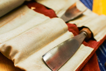 Detail view on set of chisels in textile wrapper. Detail of gouge.