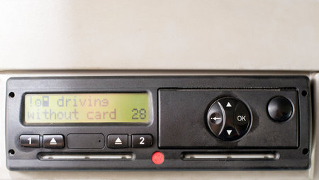 Digital tachograph display reads DRIVING WITHOUT CARD. No inserted card in the device. Insert the...