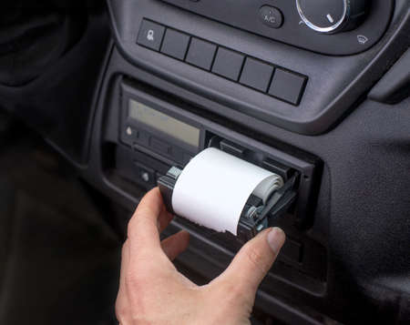 Digital tachograph with an open printer and visible roll of paper. Paper roll Replacement in a truck digital tachographの写真素材