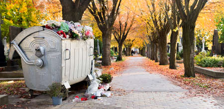 Waste bin among Trees in bright fall colors in the cemetery. Graves and golden maple leaves on All Souls Day,の写真素材