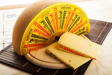 Olomouc Czech Rep Jan 21st 2015 Appenzeller cheese loaf with slices on a wooden plateのeditorial素材