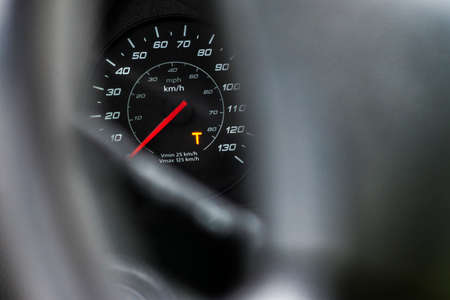 Capital T orange warning lit on speedometer of a heavy truck. Digital tachograph indicates 15 minutes left before the driver must take a brake after 4,5 hours of driving.の写真素材