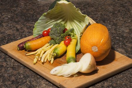 Arrangement of many different vegetables on a cutting boardの写真素材