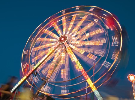 blurs and color effects created by rides at the amusement park の写真素材