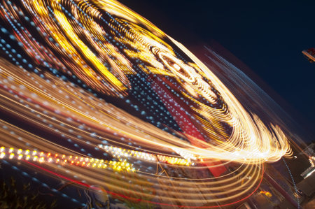 blurs and color effects created by rides at the amusement park 