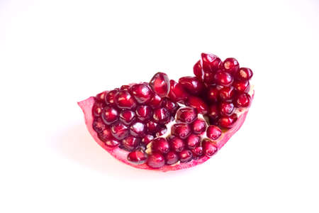 Pomegranate fruit isolated on white background. Healthy food pomegranate slices. Red juicy chunk of pomegranateの写真素材