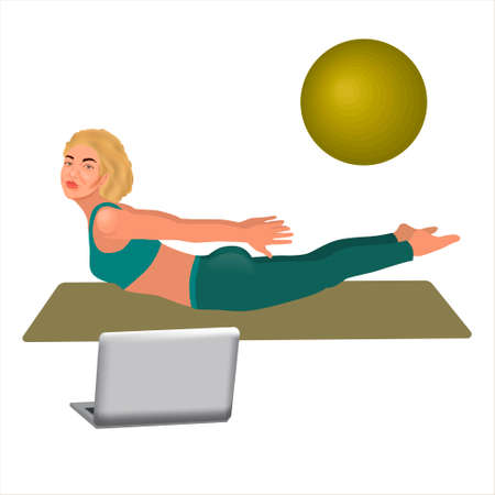 Beautiful sporty blonde woman practicing sarpasana pose - in front of her laptop, wearing sport blue outfit. Viparita Yoga pose. Woman workout fitness, aerobic and exercises with fitness ball.の写真素材