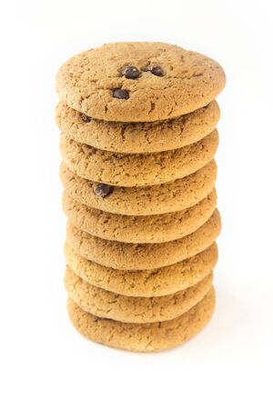 A tower of oatmeal cookies with chocolate chips stacked on a white isolated background.の写真素材