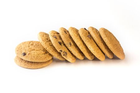 Oatmeal cookies with chocolate chips lie sideways on a white background.の写真素材