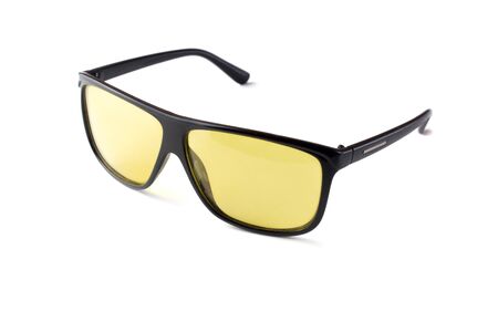 black plastic sunglasses with yellow lenses on a white isolated background.の写真素材
