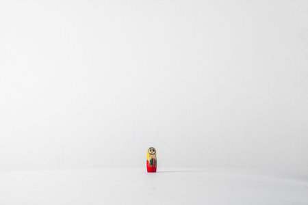 One very small nesting doll in the center on a white background.