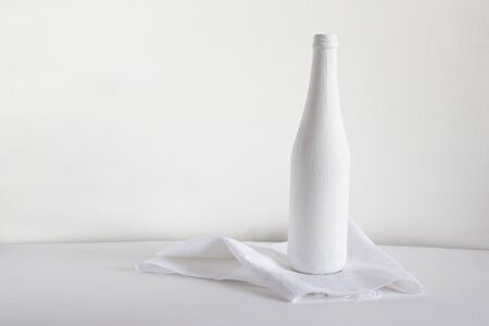 White bottle on a towel on a light background.の写真素材