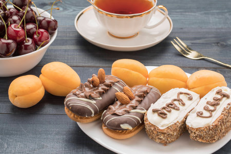 FruitCake with apricots cherries on a plate and tea and tea cake