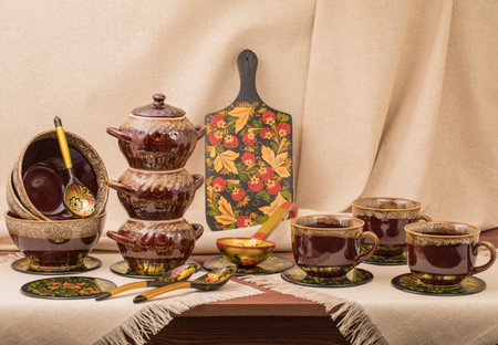 Clay pots for cooking with cups and boards on a table with a backgroundの写真素材
