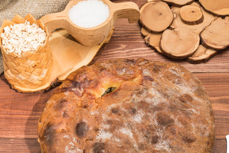 Rustic hot pie with meat and potato stuffing on the table