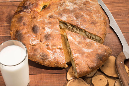 Rustic hot pie with meat and potato stuffing on the tableの写真素材