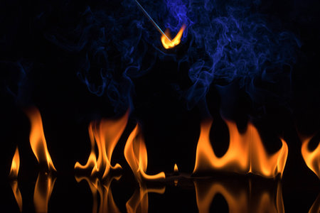 fire on a black background and a flameの写真素材