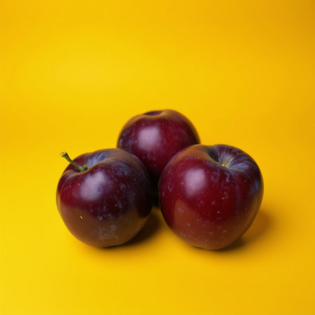 Red plums on a yellow background. Healthy food. Selective focus.の素材
